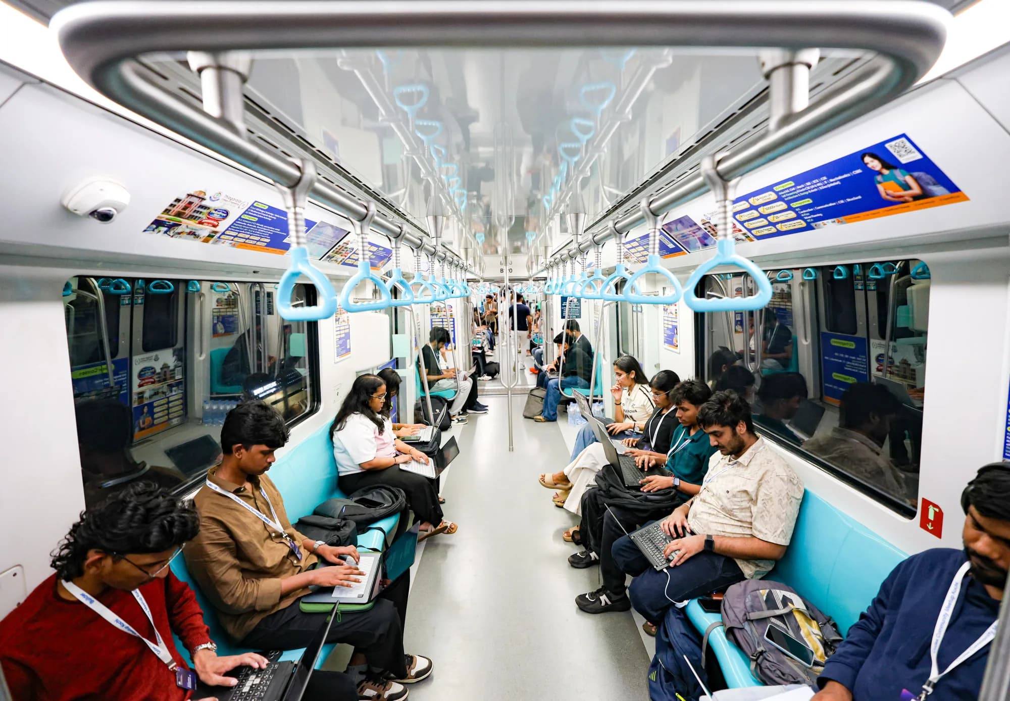 Builders working on laptops aboard the Kochi Metro during Codex Nightline
